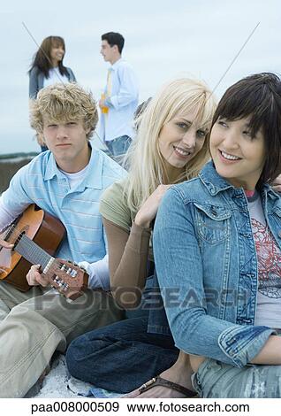 Friends hanging out together View Large Photo Image Stock Photo - Friends hanging out together. Fotosearch