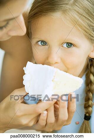 Stock Photography - Girl eating cake. Fotosearch