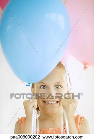 Girl holding balloons View Large Photo Image Stock Image - Girl holding balloons. Fotosearch