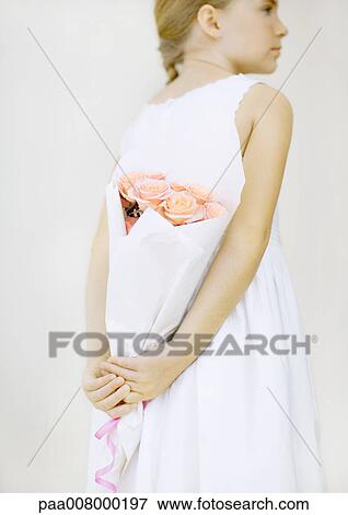 Girl holding bouquet of roses behind back View Large Photo Image Stock Photo - Girl holding bouquet of roses behind back. Fotosearch