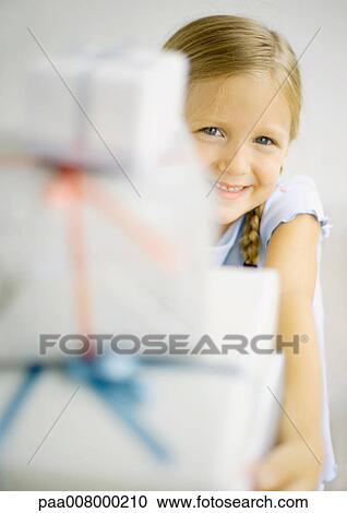 Girl holding stack of gifts View Large Photo Image Stock Image - Girl holding stack of gifts. Fotosearch