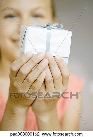 Girl holding up present View Large Photo Image Stock Image - Girl holding up present. Fotosearch