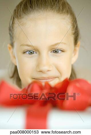 Stock Image - Girl looking at present. Fotosearch