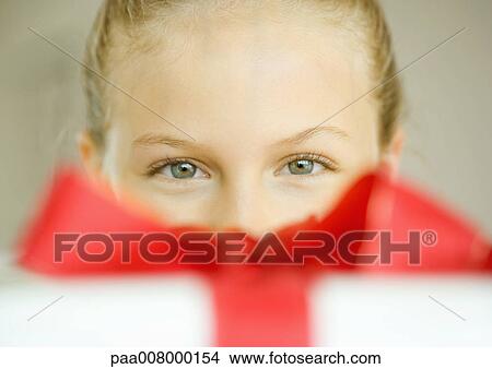 Girl looking over present View Large Photo Image Picture - Girl looking over present. Fotosearch