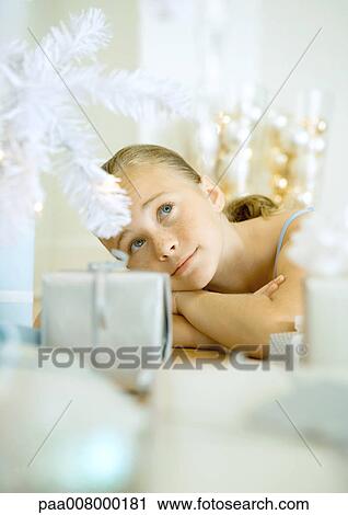 Girl lying on floor next to Christmas tree View Large Photo Image Stock Image - Girl lying on floor next to Christmas tree. Fotosearch