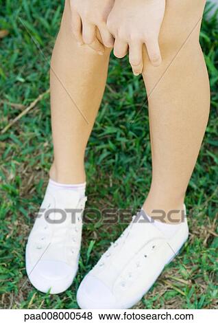 Stock Photo - Girl with hands on knees, close-up. Fotosearch