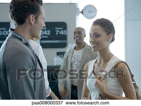 Group of people standing, smiling, in boarding area of airport View Large Photo Image Stock Photo - Group of people standing, smiling, in boarding area of airport. Fotosearch