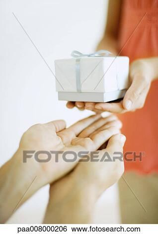 Hands giving and receiving gift View Large Photo Image Stock Photograph - Hands giving and receiving gift. Fotosearch