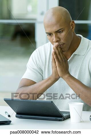 Stock Image - Le Club Multimedia neon sign with "Hotel" sign in background, blurred. Fotosearch