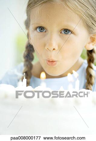 Little girl blowing out candles on birthday cake View Large Photo Image Stock Photo - Little girl blowing out candles on birthday cake. Fotosearch