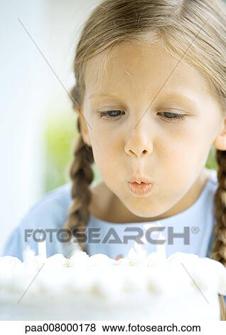 Little girl blowing out candles on birthday cake View Large Photo Image Stock Photo - Little girl blowing out candles on birthday cake. Fotosearch