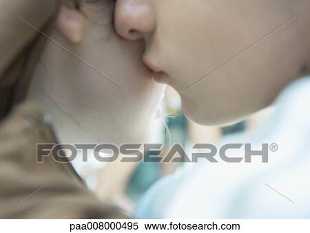 Stock Photography - Man kissing woman's cheek, extreme close-up. Fotosearch