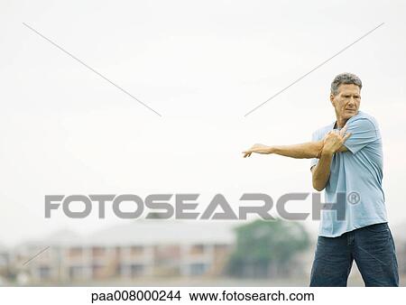 Man stretching, outdoors View Large Photo Image Picture - Man stretching, outdoors. Fotosearch