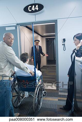 Man with traveler in wheelchair at boarding gate View Large Photo Image Stock Image - Man with traveler in wheelchair at boarding gate. Fotosearch