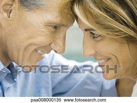 Mature couple looking at each other, foreheads together, close-up View Large Photo Image Stock Photography - Mature couple looking at each other, foreheads together, close-up. Fotosearch