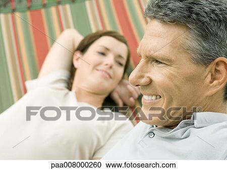 Mature couple lounging in hammock View Large Photo Image Stock Image - Mature couple lounging in hammock. Fotosearch
