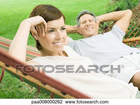 Mature couple lounging in hammock View Large Photo Image Stock Image - Mature couple lounging in hammock. Fotosearch