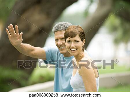Stock Photo - Mature couple, man waving. Fotosearch