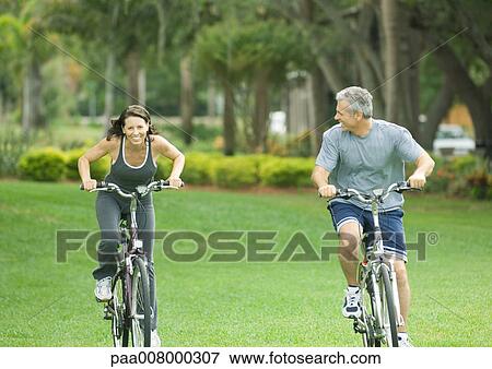 Mature couple riding bikes View Large Photo Image Stock Photo - Mature couple riding bikes. Fotosearch