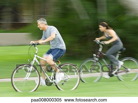 Mature couple riding bikes View Large Photo Image Stock Photography - Mature couple riding bikes. Fotosearch