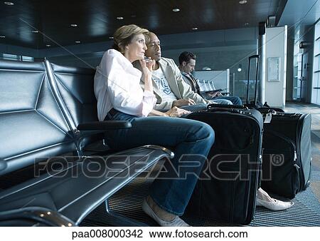 Stock Image - People in airport lounge. Fotosearch