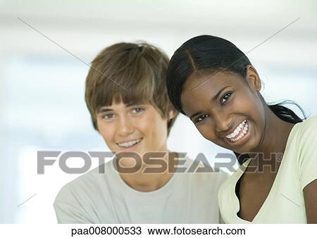 Stock Image - Preteen boy and girl smiling. Fotosearch
