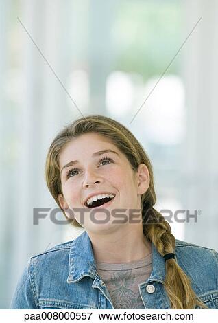 Preteen girl looking up in surprise View Large Photo Image Stock Photo - Preteen girl looking up in surprise. Fotosearch