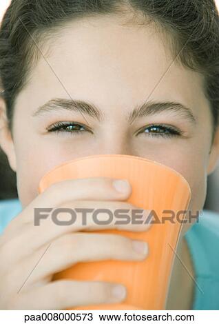 Teenage girl drinking from cup View Large Photo Image Stock Image - Teenage girl drinking from cup. Fotosearch