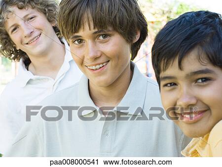 Stock Image - Three preteen boys, smiling. Fotosearch