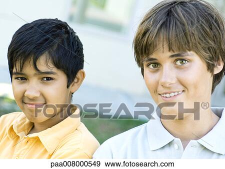 Two preteen boys smiling at camera View Large Photo Image Stock Photo - Two preteen boys smiling at camera. Fotosearch