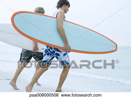 Two surfers running toward ocean View Large Photo Image Stock Photo - Two surfers running toward ocean. Fotosearch