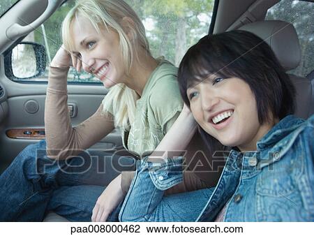 Two women sitting in car View Large Photo Image Stock Image - Two women sitting in car. Fotosearch