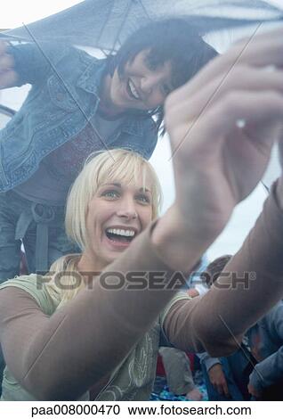 Two young women putting up tent View Large Photo Image Stock Image - Two young women putting up tent. Fotosearch
