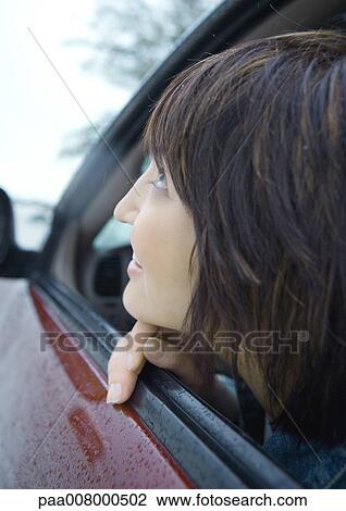 Woman looking out of car window View Large Photo Image Stock Image - Woman looking out of car window. Fotosearch