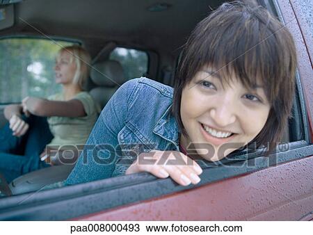 Woman sticking head out of car window View Large Photo Image Stock Image - Woman sticking head out of car window. Fotosearch