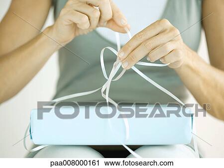 Stock Image - Woman wrapping present. Fotosearch