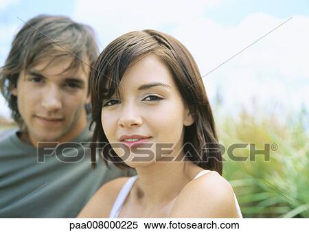 Stock Photography - Young couple, focus on woman in foreground. Fotosearch