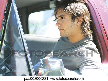 Young man sitting in pick-up truck View Large Photo Image Stock Image - Young man sitting in pick-up truck. Fotosearch