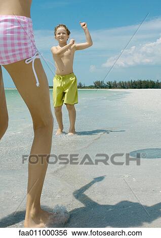 Boy and girl playing ball on beach View Large Photo Image Stock Photograph - Boy and girl playing ball on beach. Fotosearch