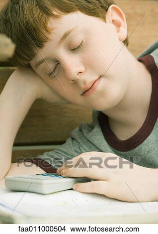 Boy dozing off as he does homework View Large Photo Image Picture - Boy dozing off as he does homework. Fotosearch