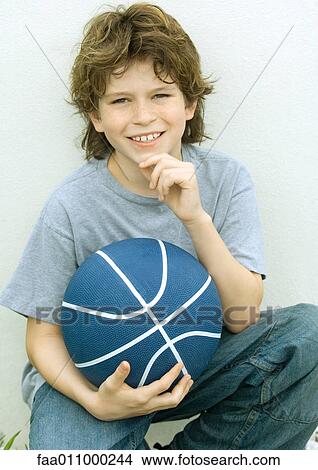 Boy holding basketball, portrait View Large Photo Image Picture - Boy holding basketball, portrait. Fotosearch