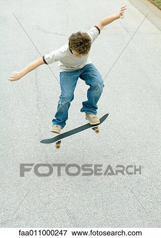 Boy jumping with skateboard View Large Photo Image Stock Photo - Boy jumping with skateboard. Fotosearch
