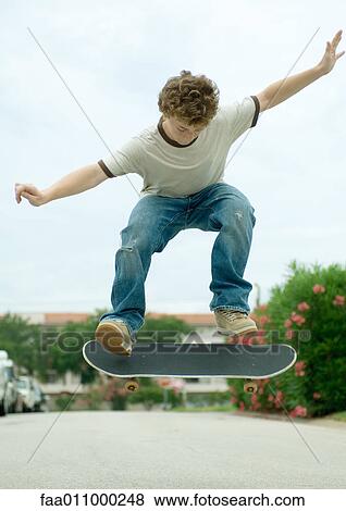 Boy jumping with skateboard View Large Photo Image Stock Photo - Boy jumping with skateboard. Fotosearch