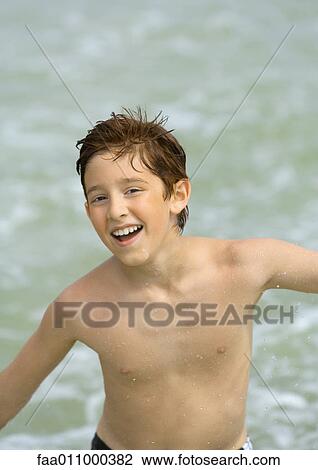 Stock Image - Boy on beach, portrait. Fotosearch
