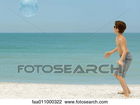 Boy playing with ball on beach View Large Photo Image Stock Image - Boy playing with ball on beach. Fotosearch