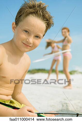 Boy smiling on beach, portrait View Large Photo Image Picture - Boy smiling on beach, portrait. Fotosearch