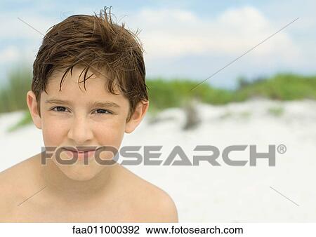 Boy smiling on beach, portrait View Large Photo Image Stock Image - Boy smiling on beach, portrait. Fotosearch