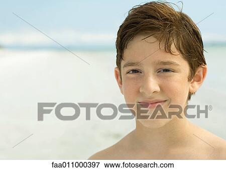 Boy smiling on beach, portrait View Large Photo Image Stock Photo - Boy smiling on beach, portrait. Fotosearch