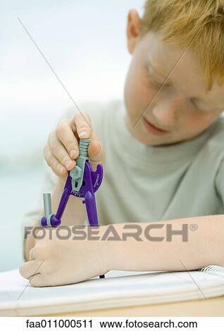 Boy using drawing compass View Large Photo Image Stock Image - Boy using drawing compass. Fotosearch