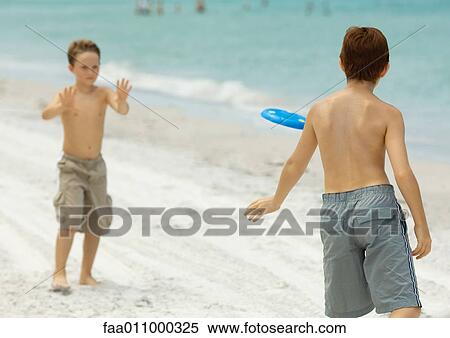 Boys playing frisbee on beach View Large Photo Image Stock Photography - Boys playing frisbee on beach. Fotosearch